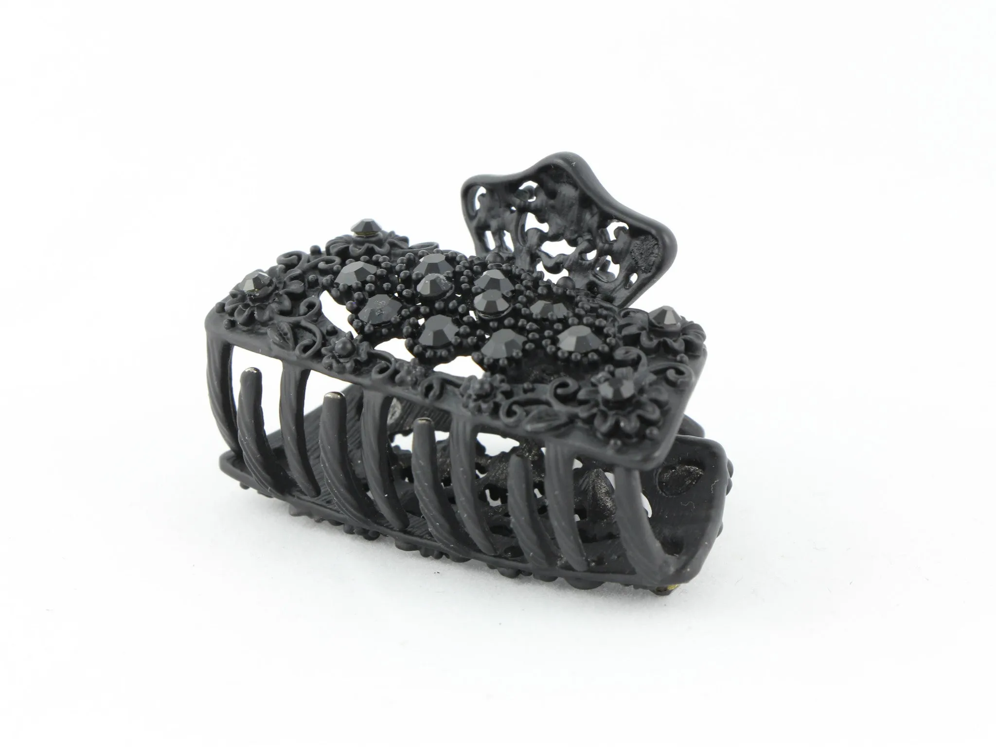 Black metal hair claw clip with black stones on a tiny floral pattern