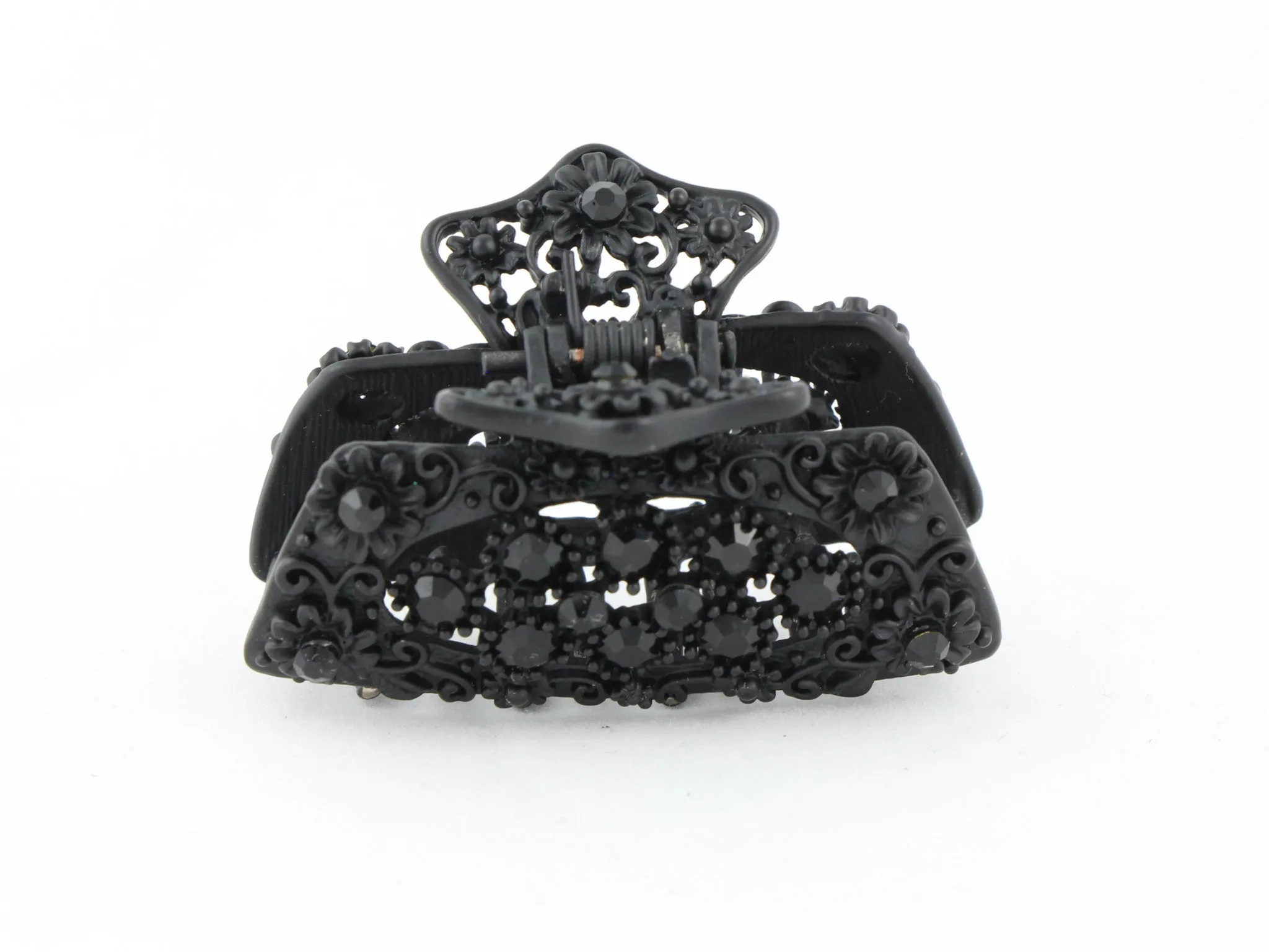 Black metal hair claw clip with black stones on a tiny floral pattern