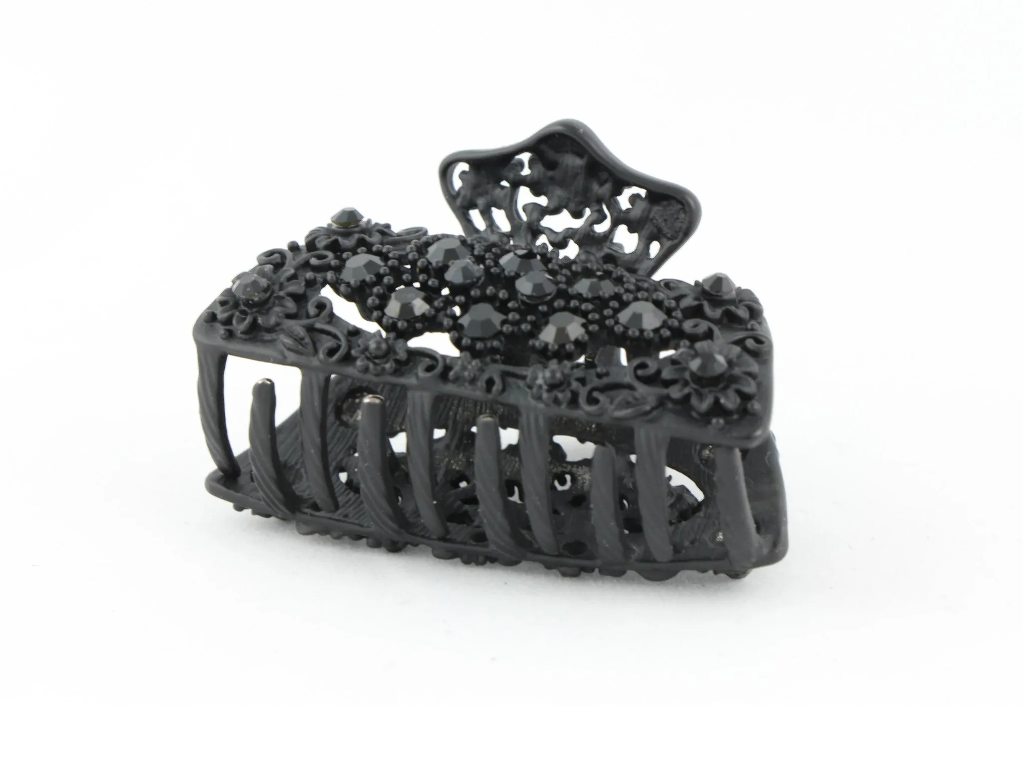 Black metal hair claw clip with black stones on a tiny floral pattern