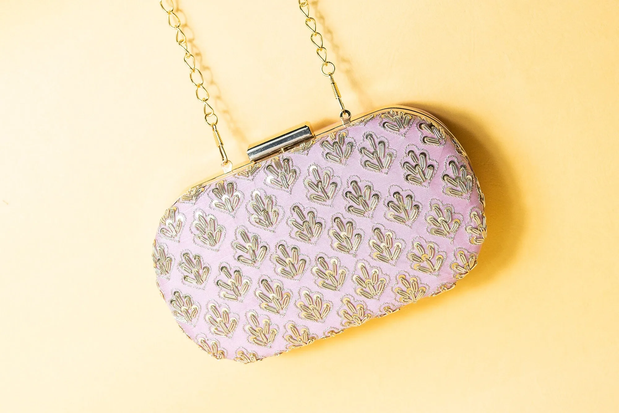 Pink metal embroidery clutch bag with detachable sling